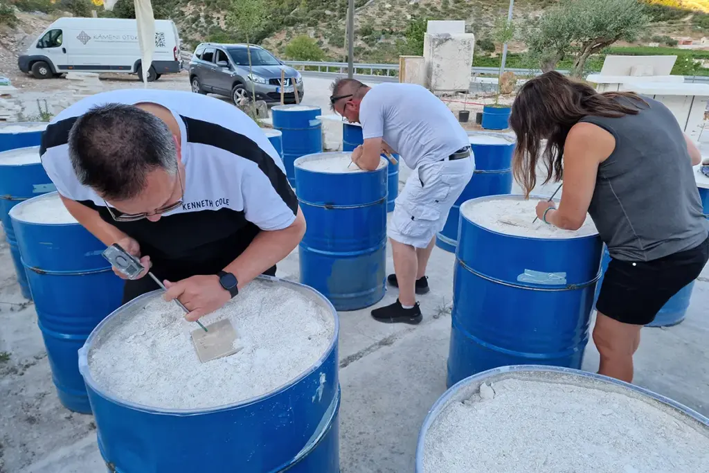 Participants carving their first Brač stone reliefs during the Journey Through Stone workshop at Kameni otok