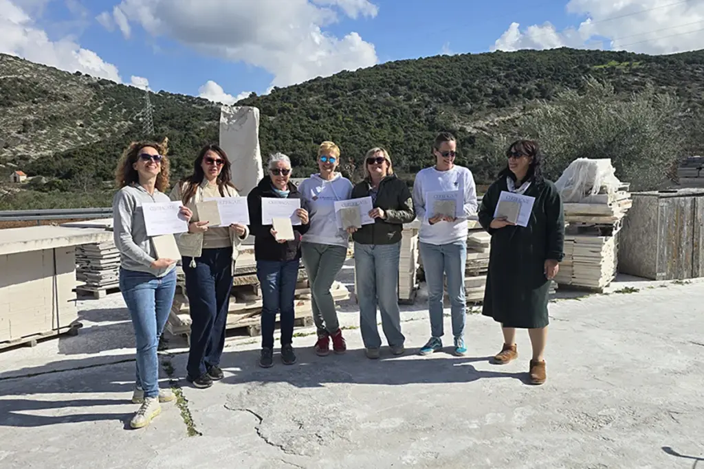 Participants proudly holding their Journey Through Stone certificates after completing a traditional stone carving workshop on the island of Brač, Croatia.