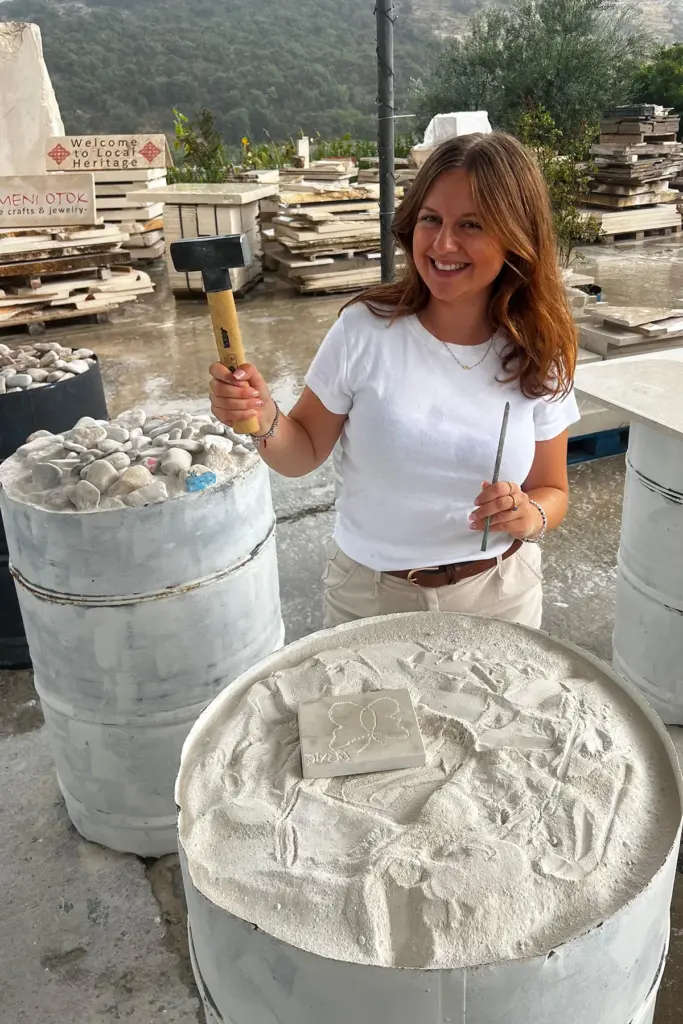Participant carving a Brač stone relief during the Journey Through Stone workshop at Kameni otok