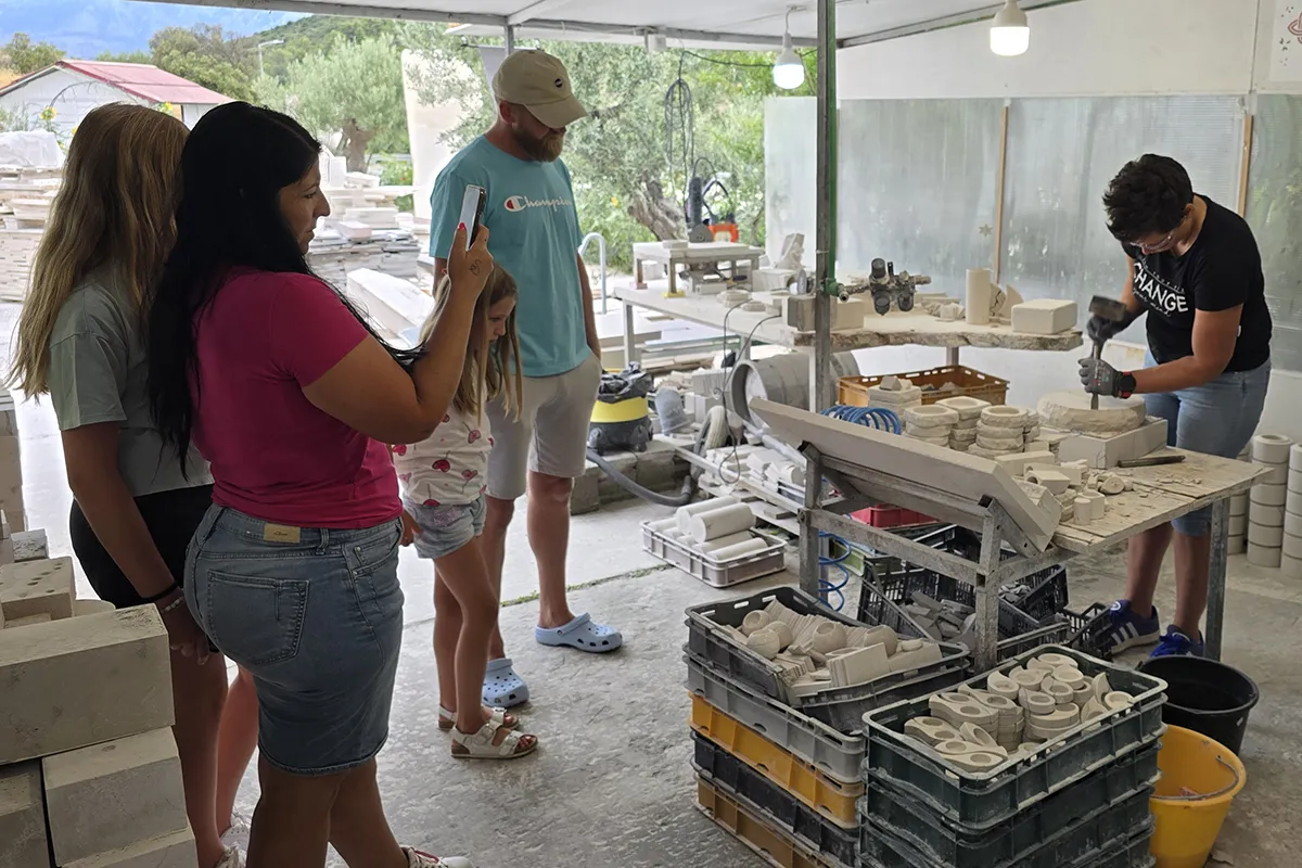 Visitors watching a live stone carving demonstration during the Journey Through Stone experience at Kameni otok on Brač