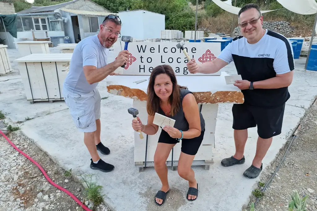 Participants proudly displaying their handcrafted stone carvings after completing the Journey Through Stone workshop at Kameni otok on Brač